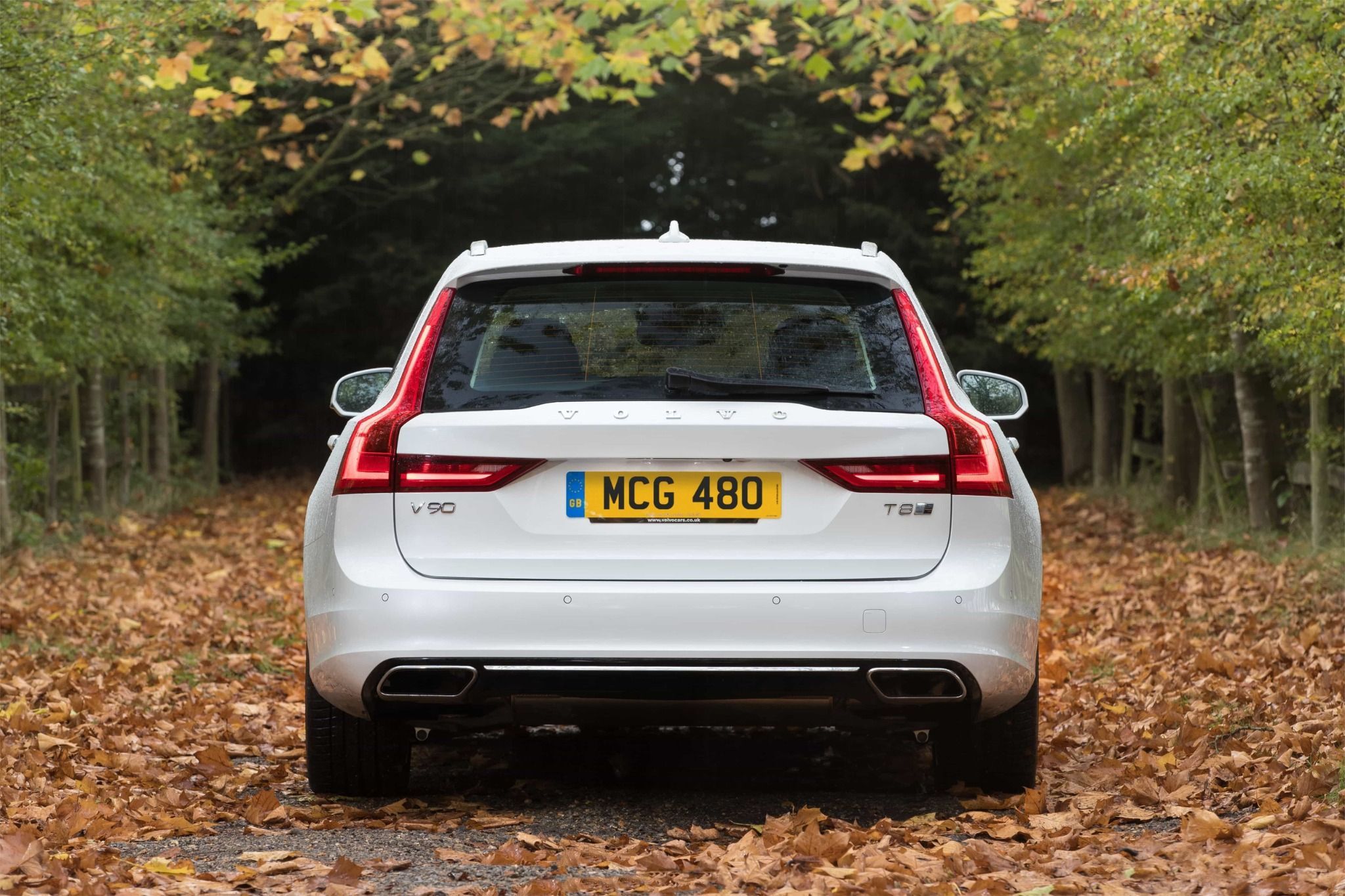 white volvo v90 from the back on a country road