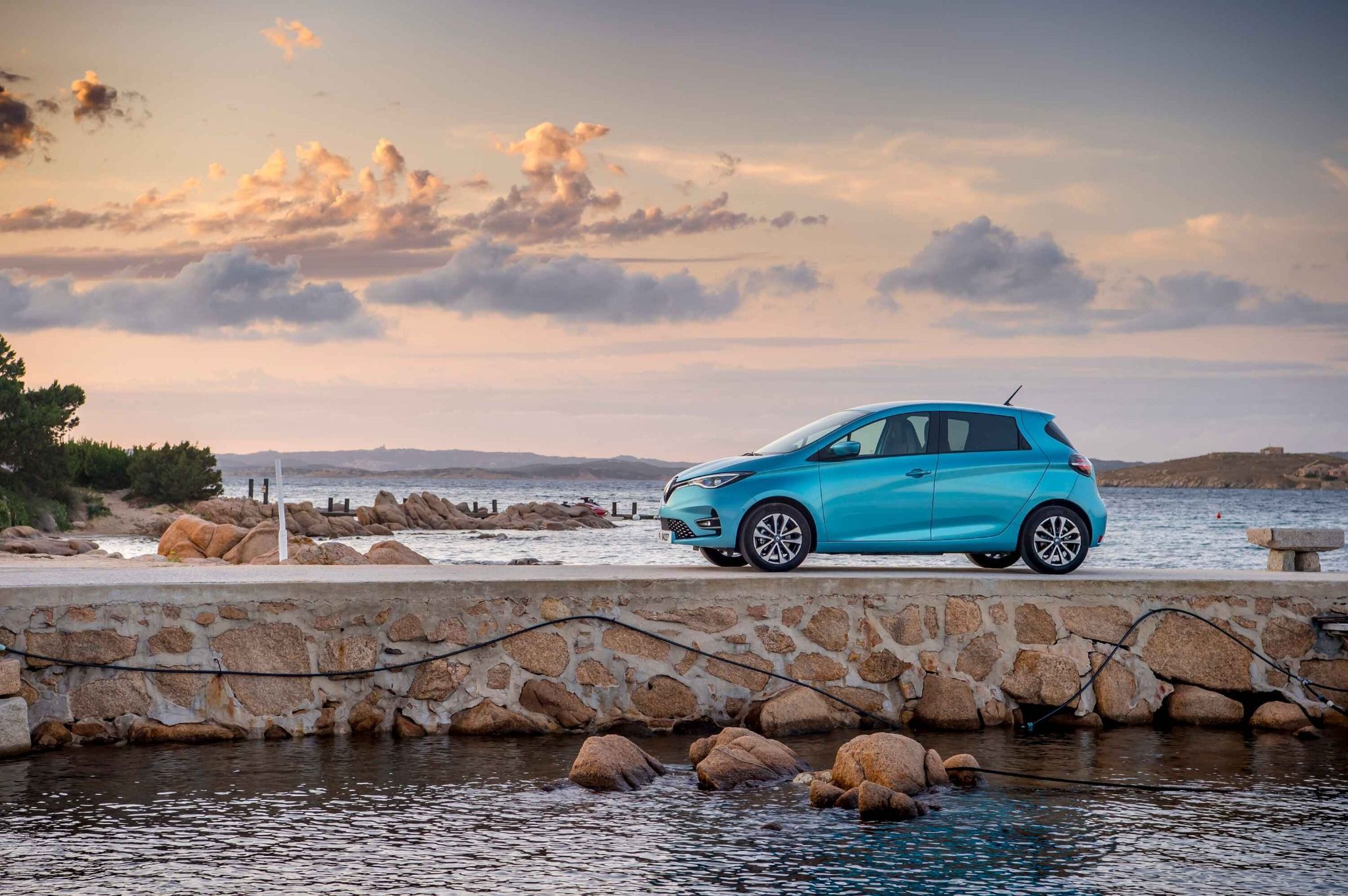 side view of blue renault zoe on a pier at sunset
