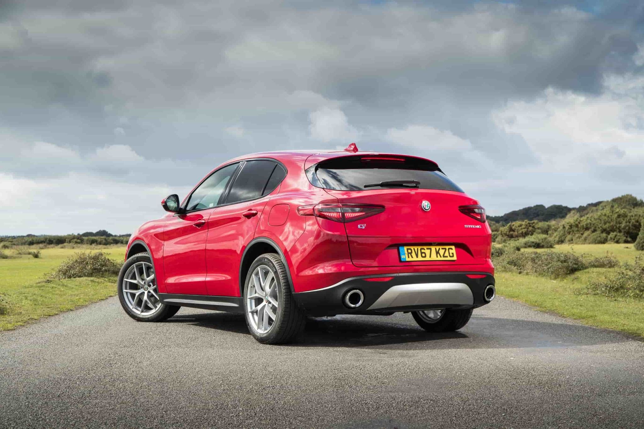 Red Alfa Romeo Stelvio Parked On a Country Road
