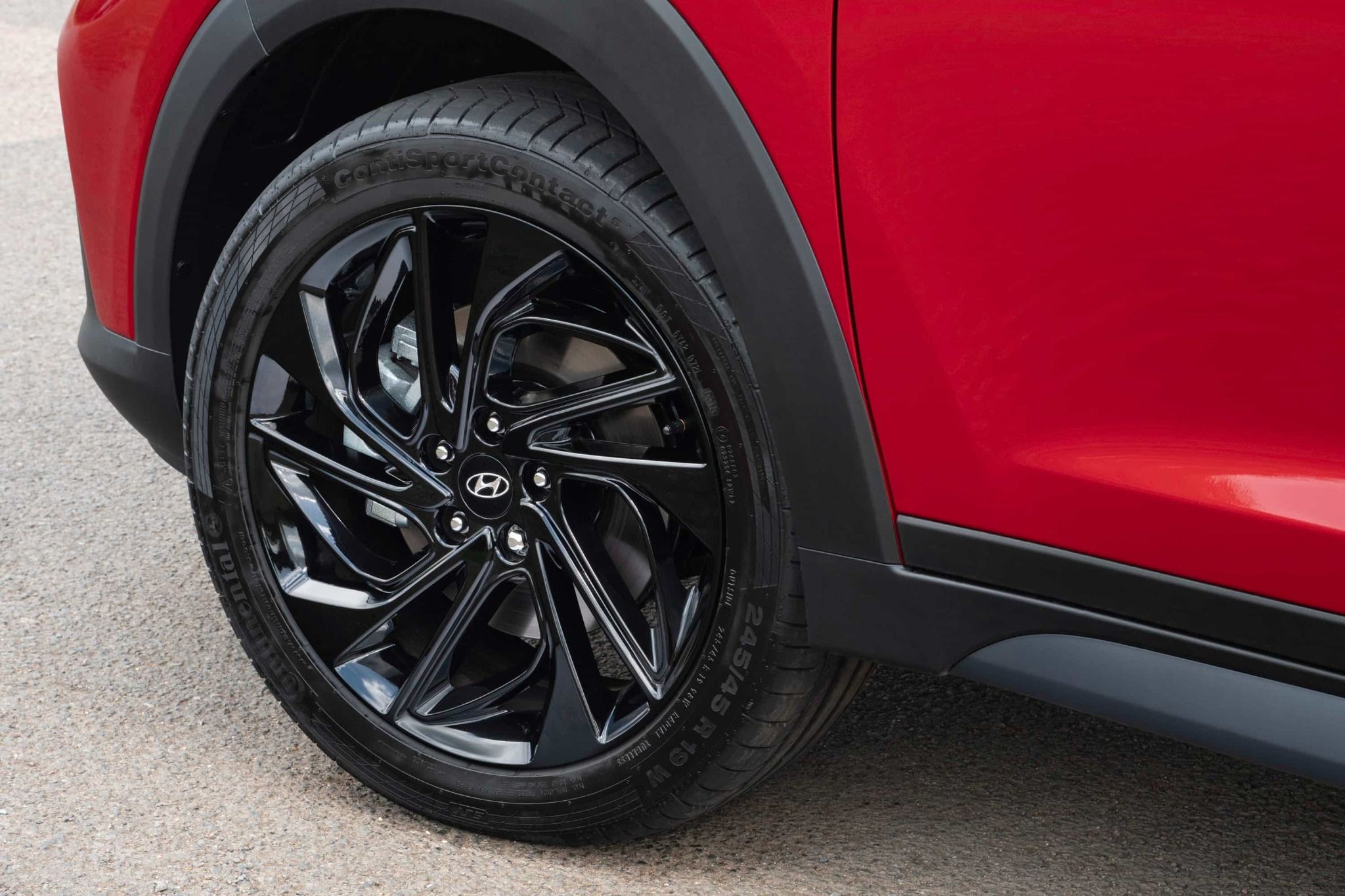 close up of the wheel on a red tuscon