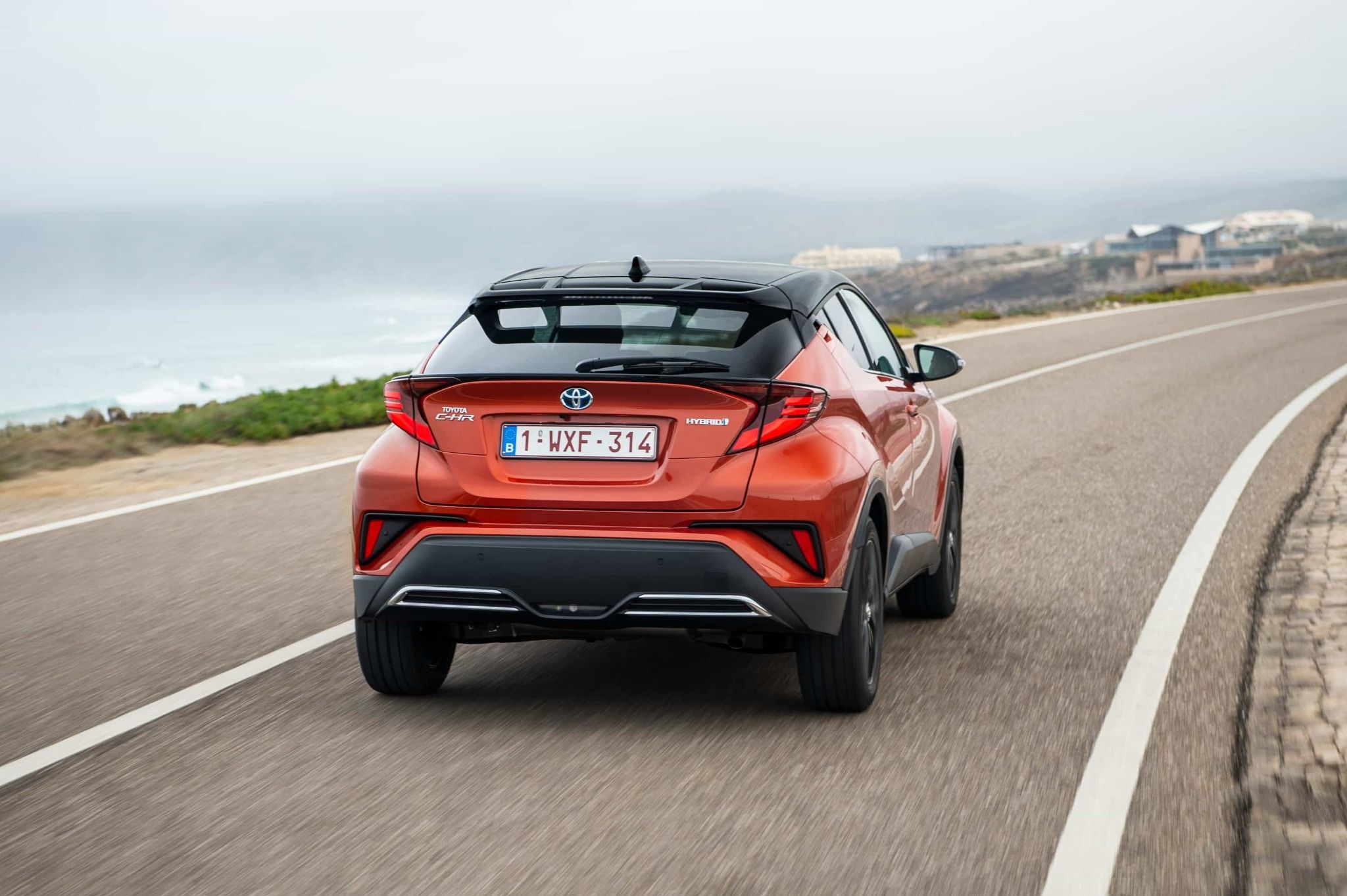 Image of Orange Toyota C-HR Driving Away From the Camera