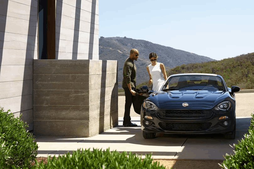 Man Holding Car Door Open For Women