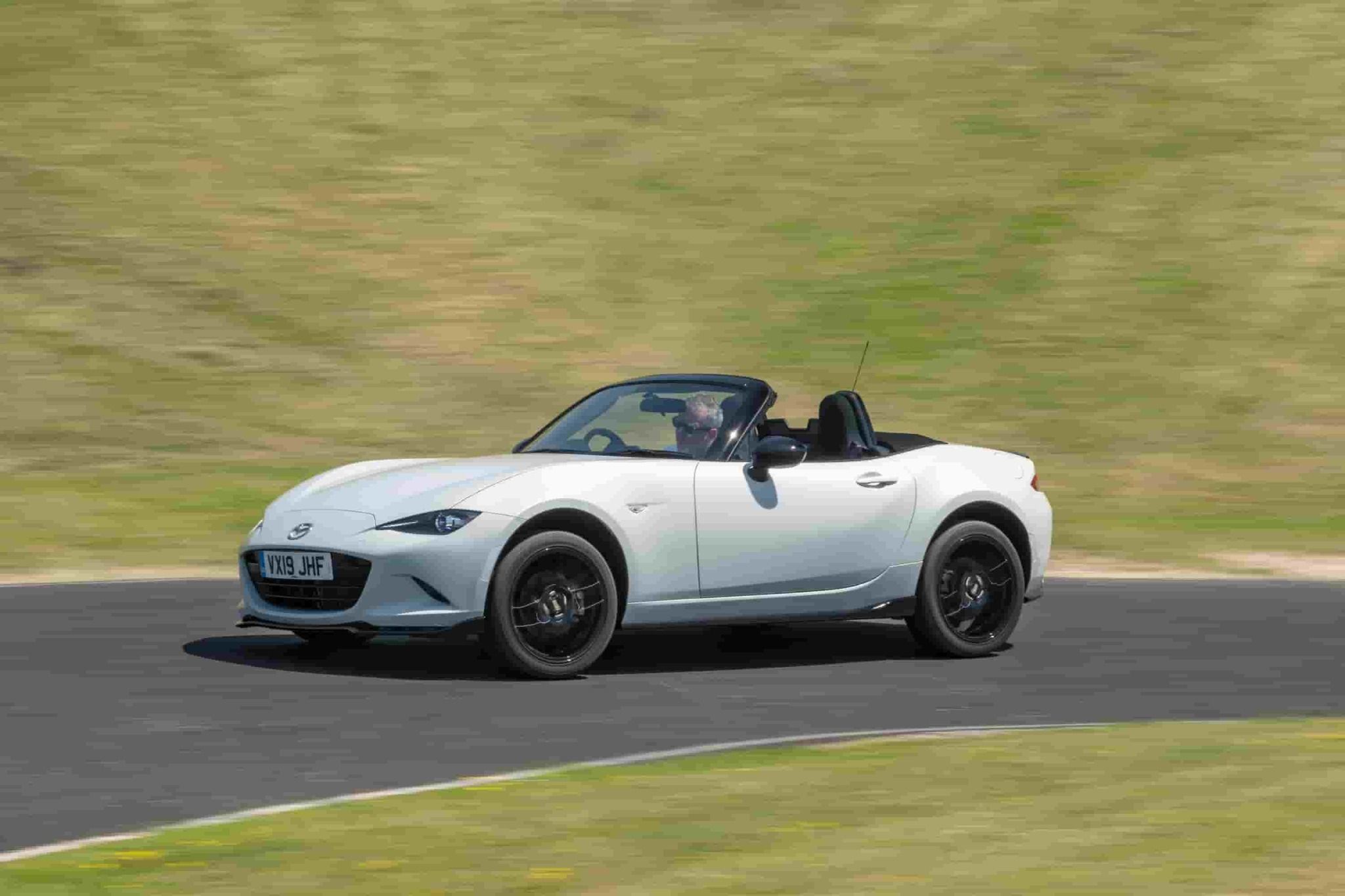Mazda mx5 driving around a corner