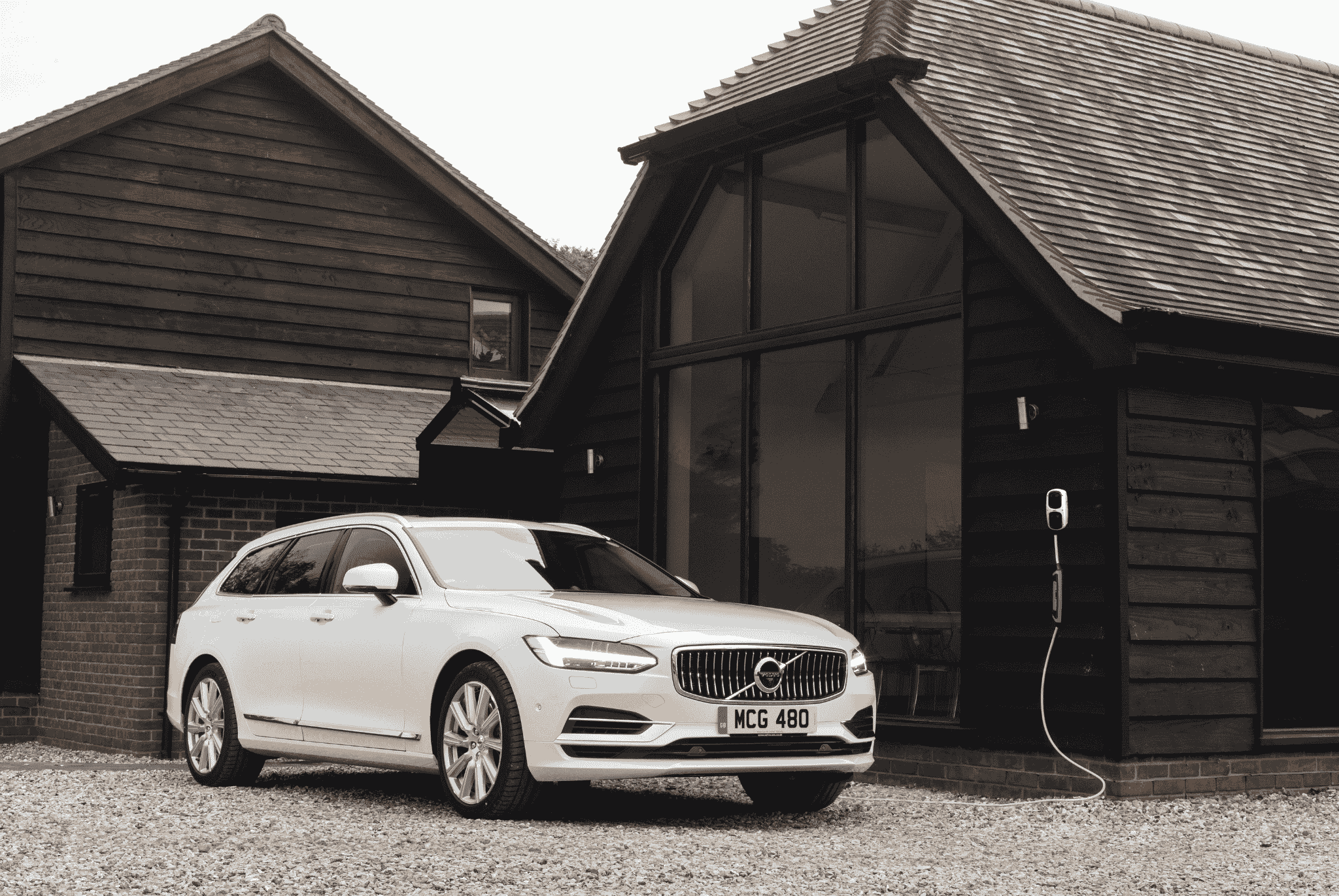 White Volvo Charging on a Wall Box Charger