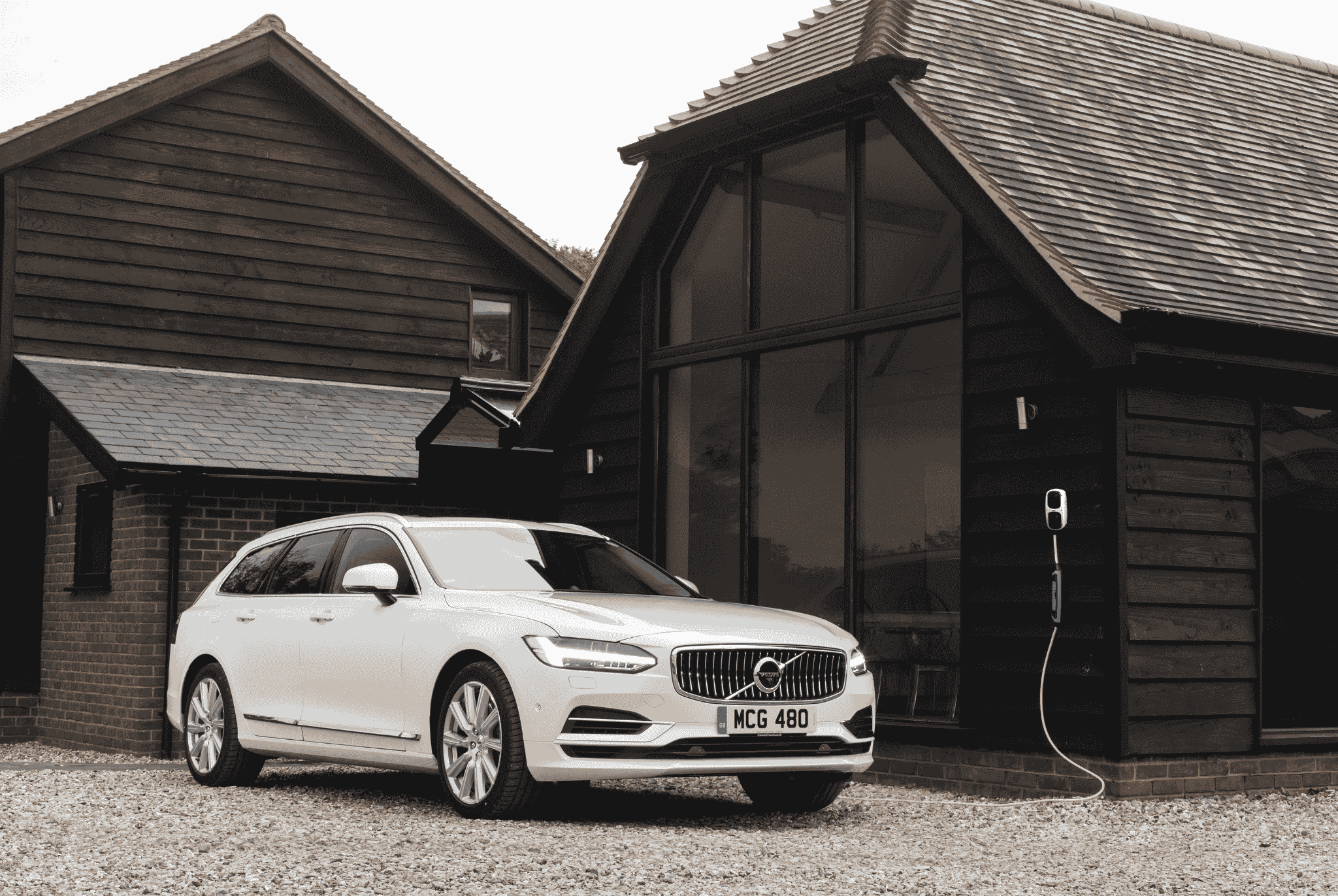 White Volvo Charging on a Wall Box Charger
