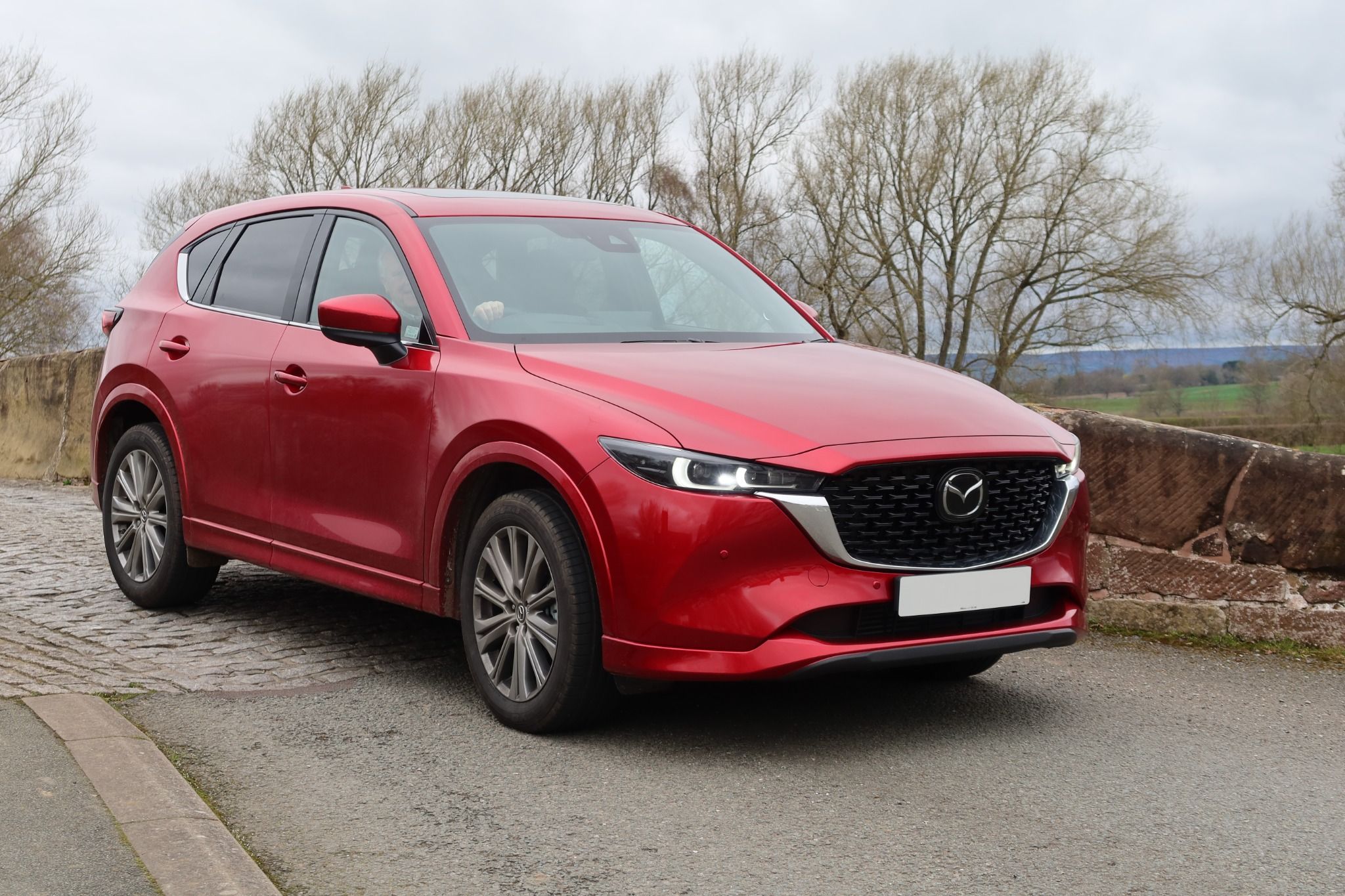 Red Mazda CX-5 parked on a country road