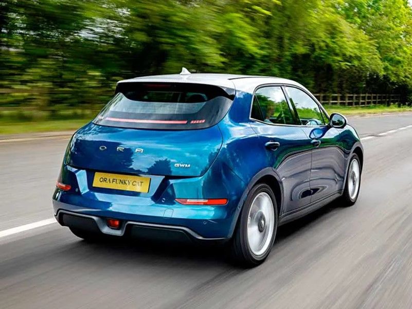 A blue ORA Funky Cat by GWM ORA A blue ORA Funky Cat by GWM ORA being driven on a country road