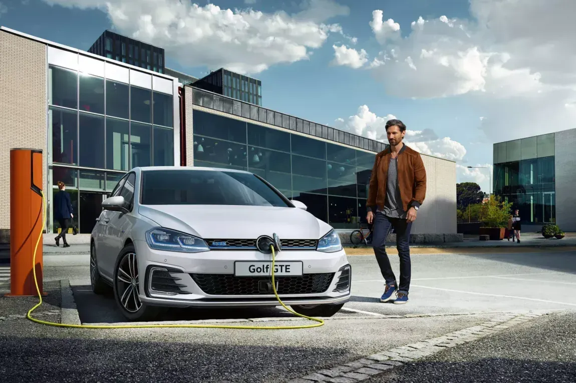 Man standing next to electric car