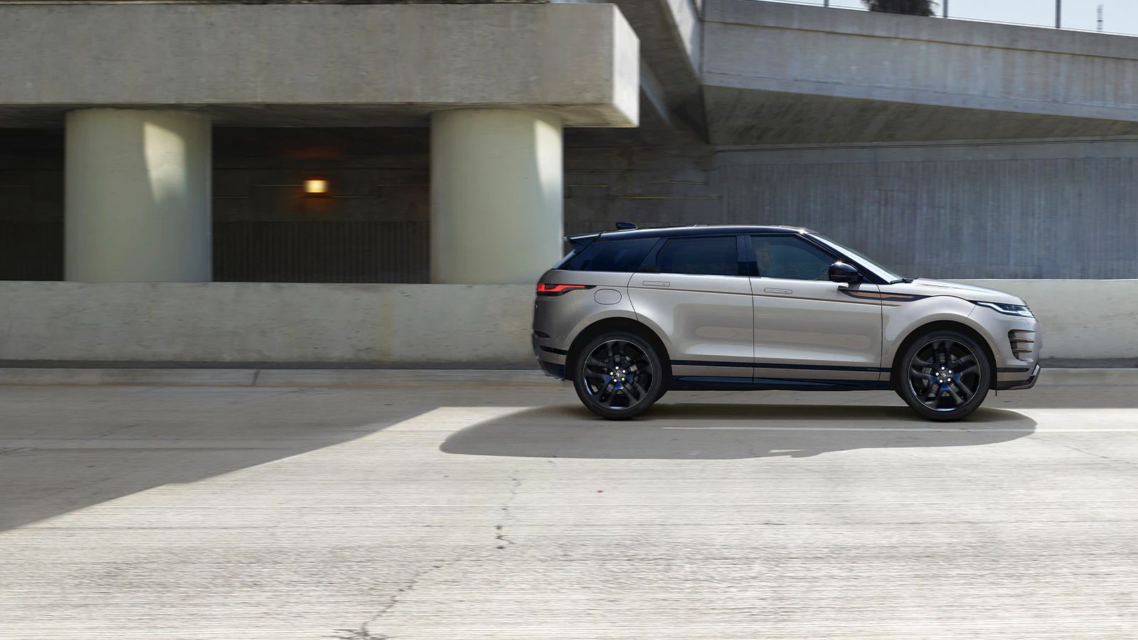 Side view of Range Rover driving on a road